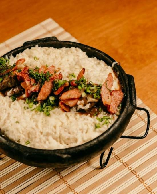 The Burgerzzz in Airdrie creamy rice served in the black clay pot.